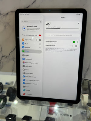 An iPad displaying the battery settings screen, photographed on a countertop with a marble-patterned surface behind it.