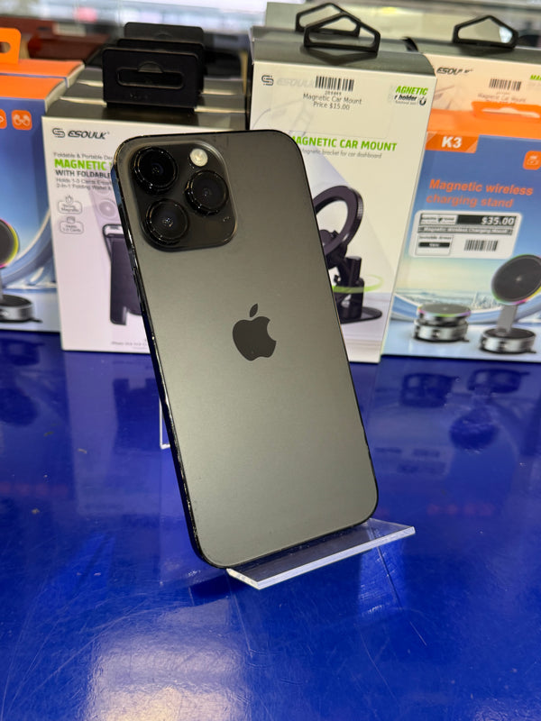 Black smartphone with Apple logo on a blue surface with packaging in the background