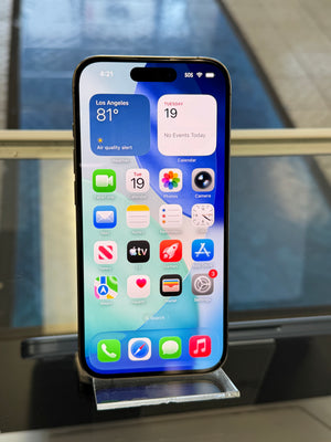 Smartphone with app icons displayed on a reflective surface