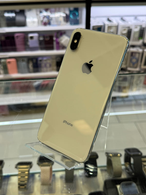 Silver iPhone XR on display in a store with blurred shelves in the background