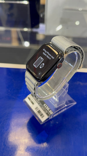 Smartwatch on a clear stand with a blue surface