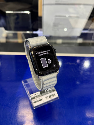 Smartwatch with a gray band on a blue surface