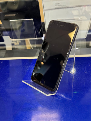 Black smartphone on a blue surface with a blurred background
