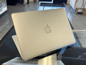Laptop with Apple logo on a stand in an indoor setting