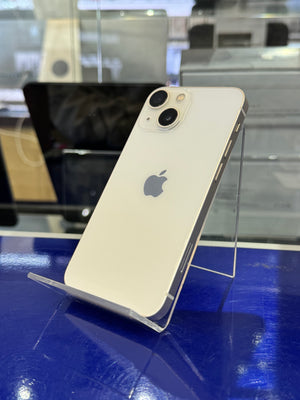 Gold iPhone 11 on a clear stand against a blue and gray background