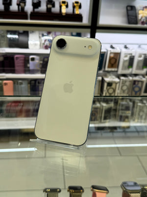 White iPhone with Apple logo on a reflective surface