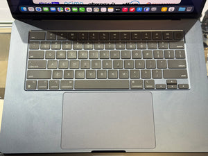 Close-up of a laptop keyboard with visible brand icons on the screen.
