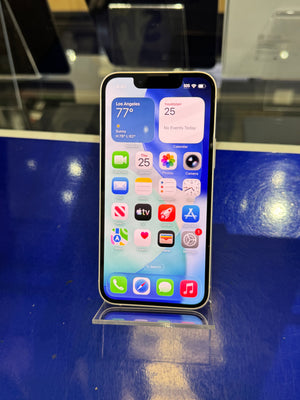 Smartphone with app icons displayed on a reflective surface