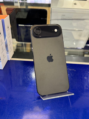 Black smartphone on a stand with an Apple logo in a store setting