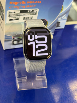 Smartwatch on a stand on a blue surface