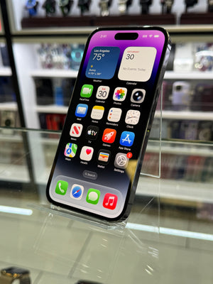 Smartphone with app icons displayed on a reflective surface
