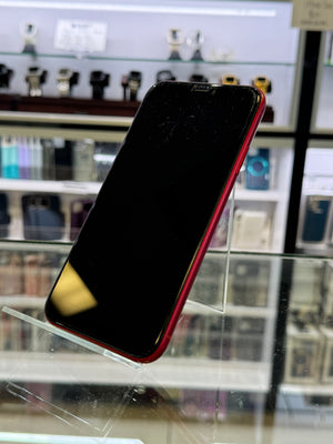 Red iPhone on a stand with blurred background
