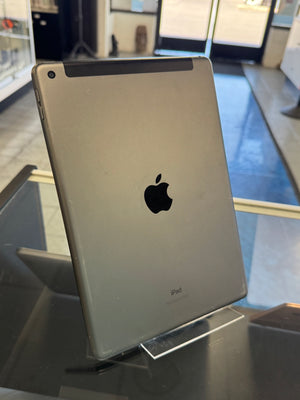 Back view of an Apple iPad on display with a blurred indoor background