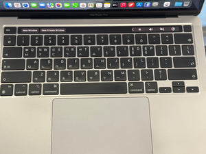 Close-up of a laptop keyboard and trackpad with a blurred background