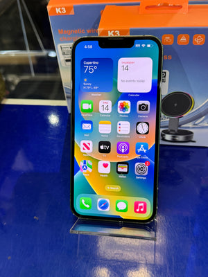 Smartphone with app icons displayed on a blue surface
