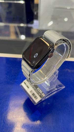 Smartwatch on a clear stand with a blue background