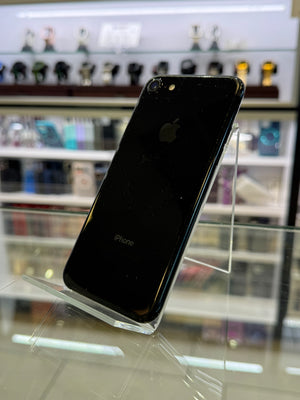 Black smartphone on a stand against a blurred background