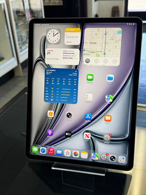 Car dashboard with a tablet displaying app icons and a map.