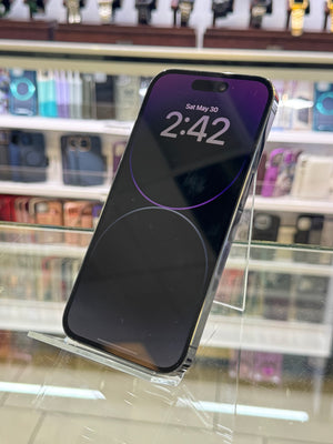 Smartphone with a reflective screen held against a blurred store window background