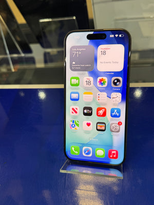 Smartphone with app icons displayed on a reflective surface