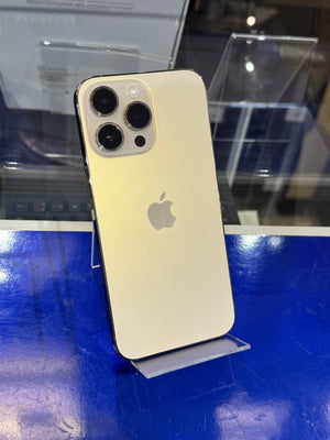 Gold smartphone with Apple logo on a blue surface