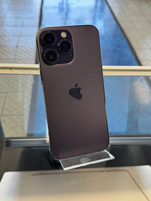 Black smartphone with Apple logo on a stand against a reflective surface