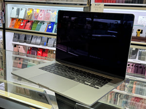 Laptop on display in a store with phone cases in the background