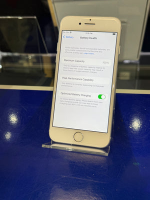 Smartphone displaying battery health information on a blue surface