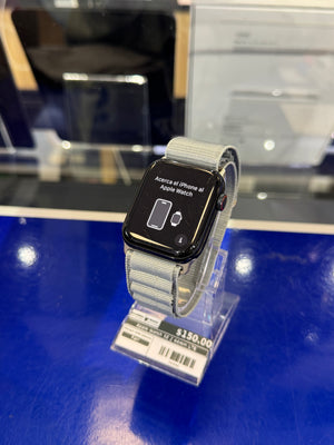 Smartwatch with gray band on a blue surface, price tag visible