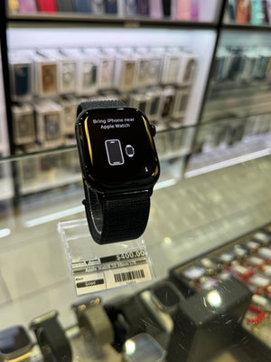 Black smartwatch on display with a price tag in a store.
