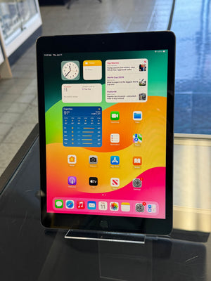 Tablet with a colorful display of app icons on a reflective surface.
