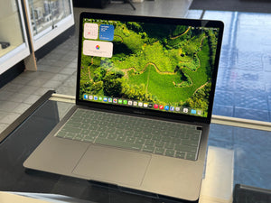 Laptop on a desk with a green screen display