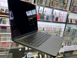 Laptop on a reflective surface with a store shelf in the background