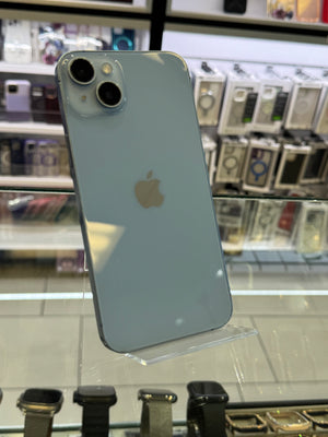 Back view of a light blue iPhone with Apple logo on a glass display stand.