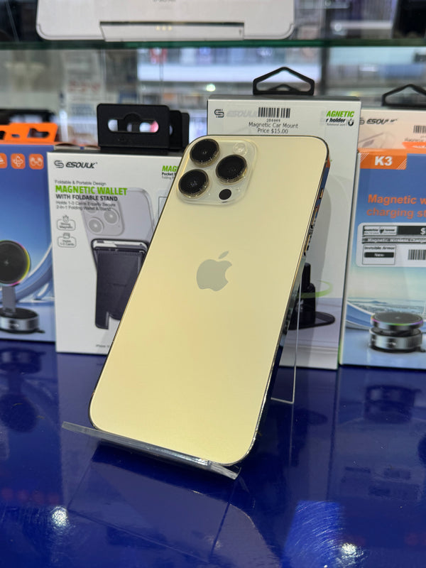 Gold smartphone with Apple logo on a reflective surface