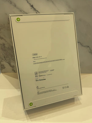 The back of a white IKEA IPAD 10.5 WiFi 6 box, showing product specifications, barcodes, and recycling symbols against a marble-patterned background.