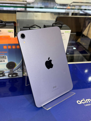 Silver iPad on a stand with a blurred store background
