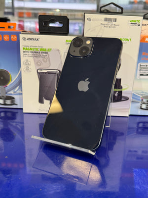 Black smartphone on a reflective surface with packaging in the background