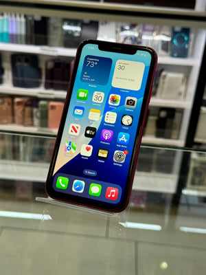 Smartphone with app icons displayed on a reflective surface