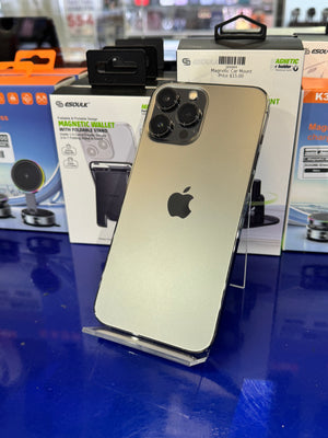 Gold iPhone with Apple logo on a blue surface with product packaging in the background