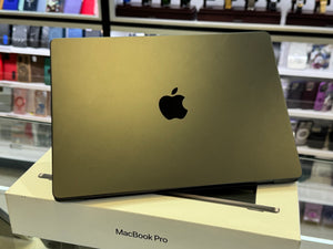 Gold MacBook Pro on a white stand with shelves in the background