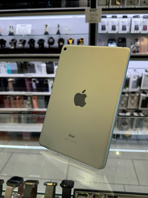 iPad with Apple logo on a stand in front of a store window