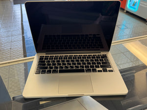 Laptop on a glass table with a blurred background