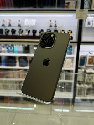 Smartphone on a stand with a blurred store shelf in the background