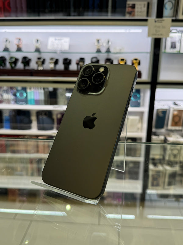 Smartphone on a stand with a blurred store shelf in the background