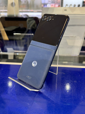 Motorola phone on a stand with a blue background