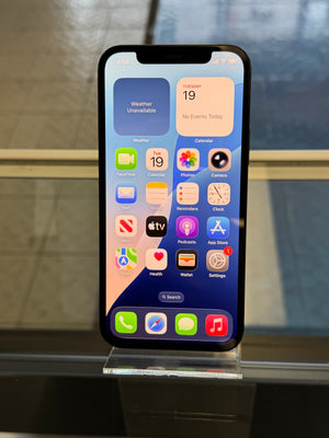 Smartphone with app icons displayed on a reflective surface