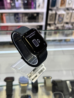 Smartwatch with a black band on a display stand in a store setting