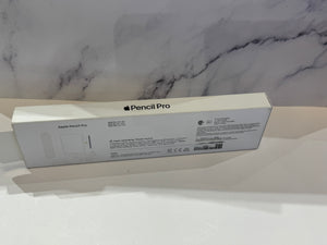 Apple Pencil Pro product box shown from the back, placed on a white surface against a white marble-patterned background.