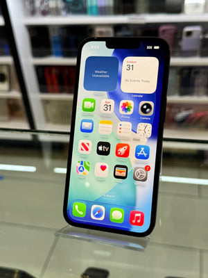 Smartphone with app icons displayed on a reflective surface